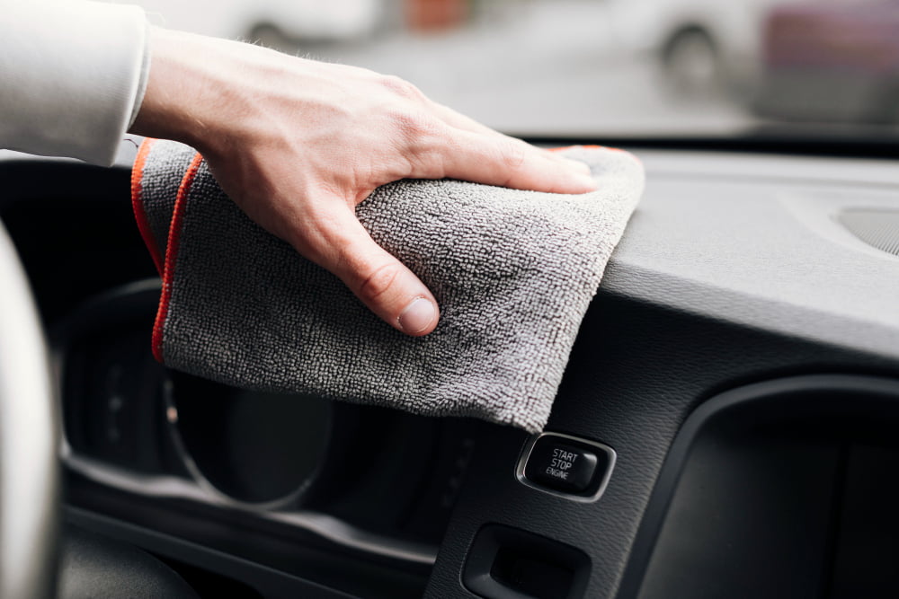 close up person cleaning car interior