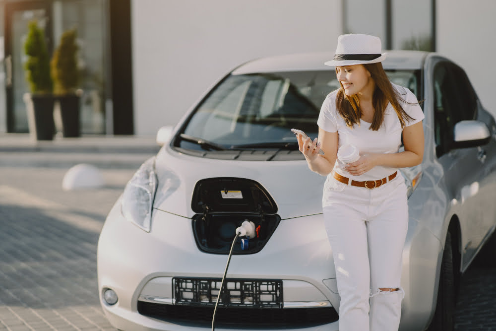 woman charging electro car electric gas station